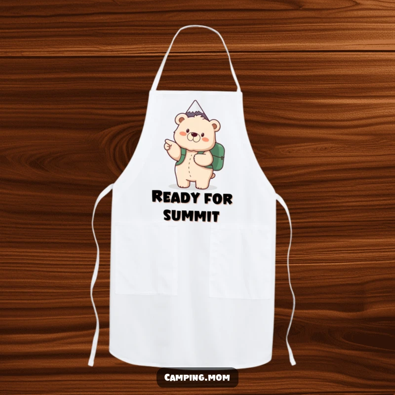 Funny apron with a fluffy mama bear holding a backpack, pointing excitedly at a mountain, ready for outdoor cooking.