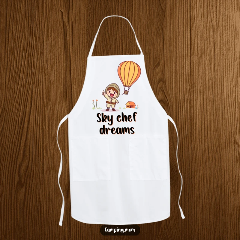 Funny apron with a whimsical camping character excitedly pointing at a colorful hot air balloon in the sky.