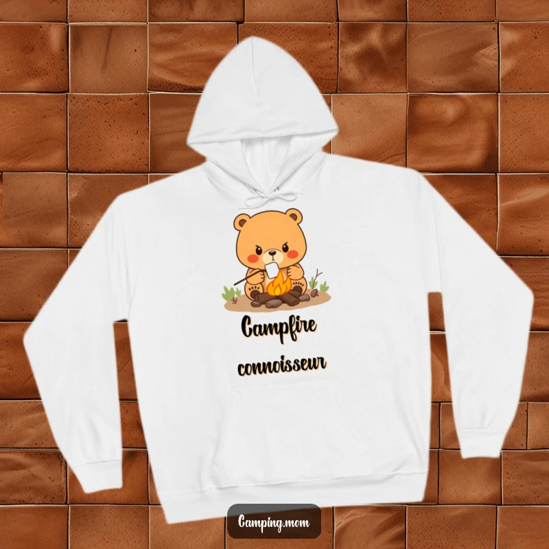 Funny hoodie showing a determined mama bear focused on roasting a marshmallow over a crackling campfire.