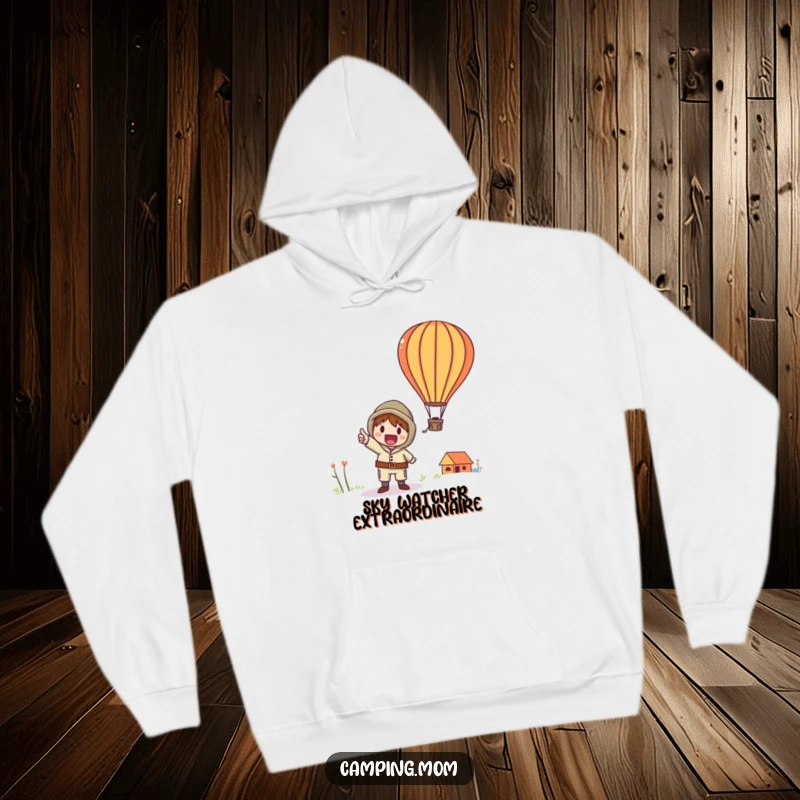 Funny hoodie showing a whimsical camping character excitedly pointing upwards at a beautifully rendered hot air balloon.