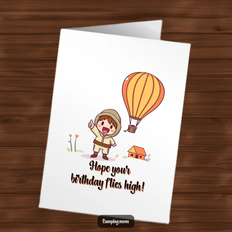 Funny Free Printable Birthday Card: A whimsical camper points with excitement at a colorful hot air balloon floating in the sky.