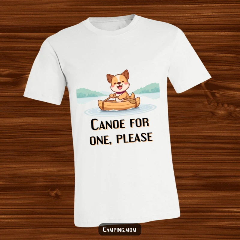 Funny Dog T-Shirt: A joyful dog happily paddles a small canoe across a serene, calm lake, enjoying the water.