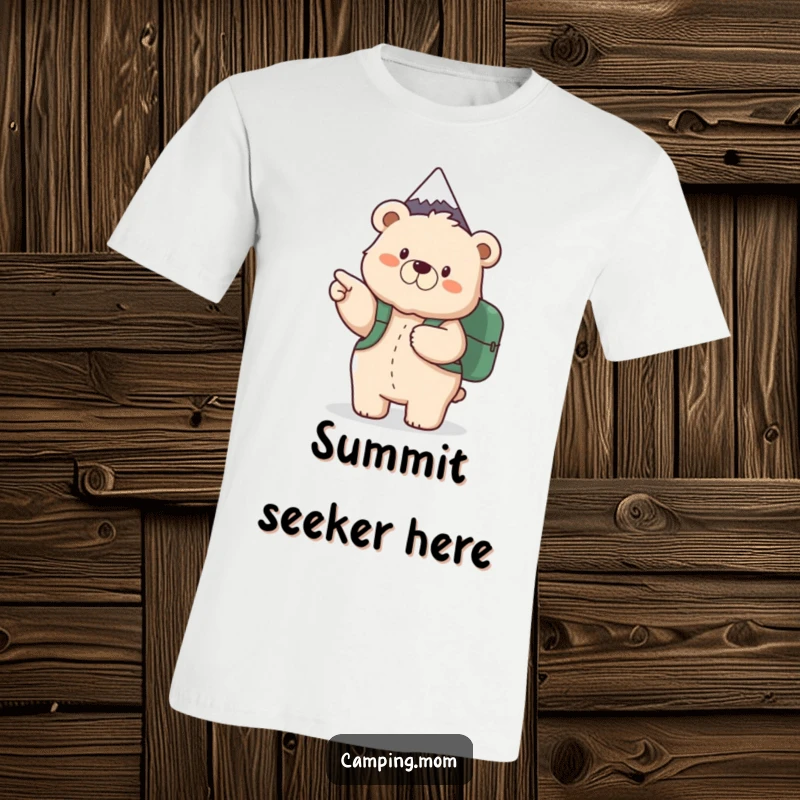 Funny t-shirt with a fluffy mama bear carrying a backpack, enthusiastically pointing towards a mountain summit, celebrating outdoor exploration.
