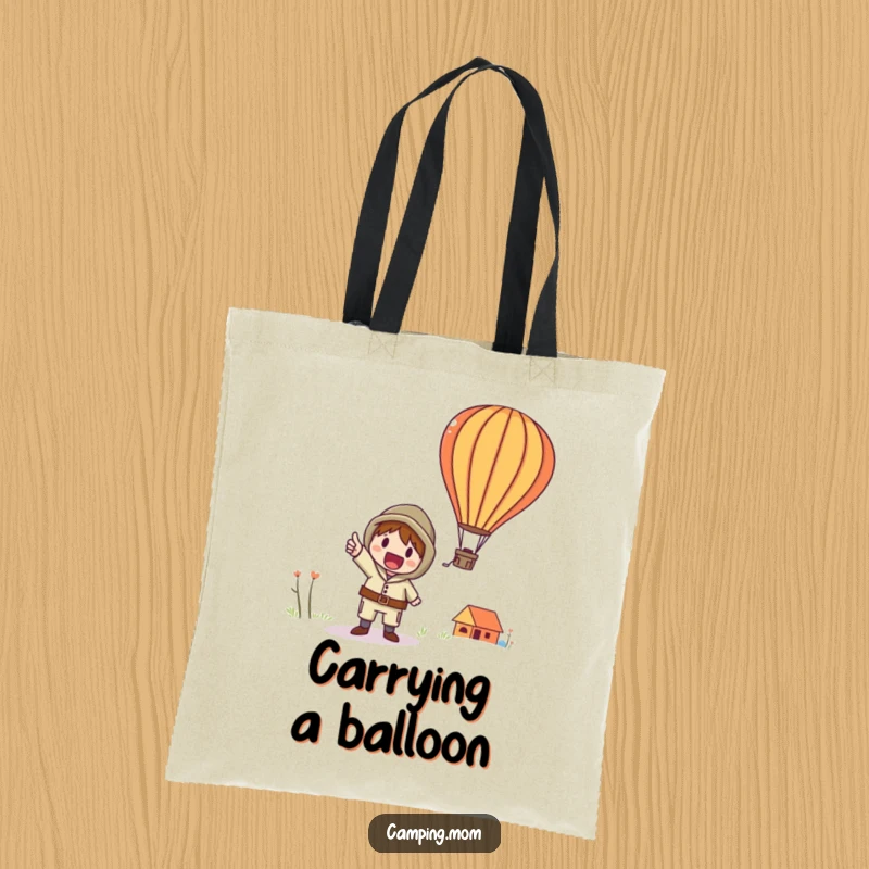Funny tote bag with a whimsical camping character excitedly pointing towards a colorful hot air balloon in the sky.